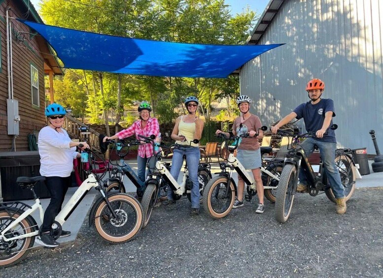 A group of people with electric bikes in an outdoor setting. 4