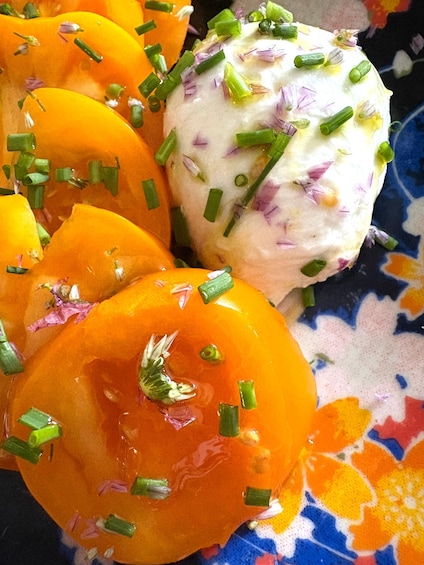 Sliced peaches garnished with chives and a dollop of cream. 4
