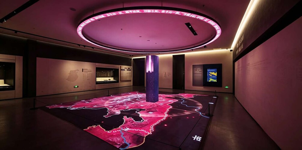 A museum interior with a circular ceiling light, a map on the floor, and informational displays. 5