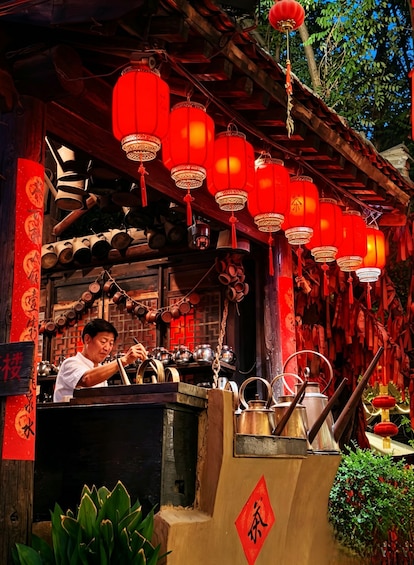 A traditional Chinese tea house with red lanterns and teapots. 4