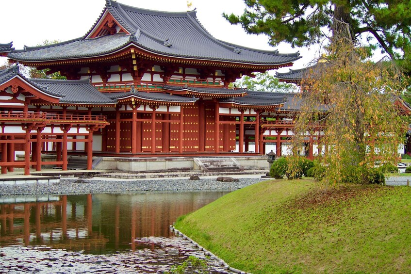 A traditional Japanese temple with a pond in front. 4