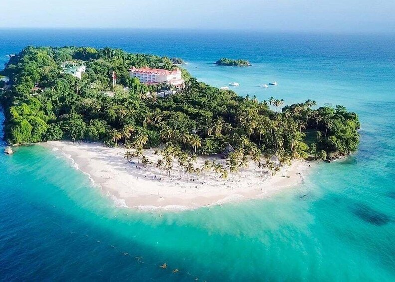 A tropical island with a beach, palm trees, and a building. 2