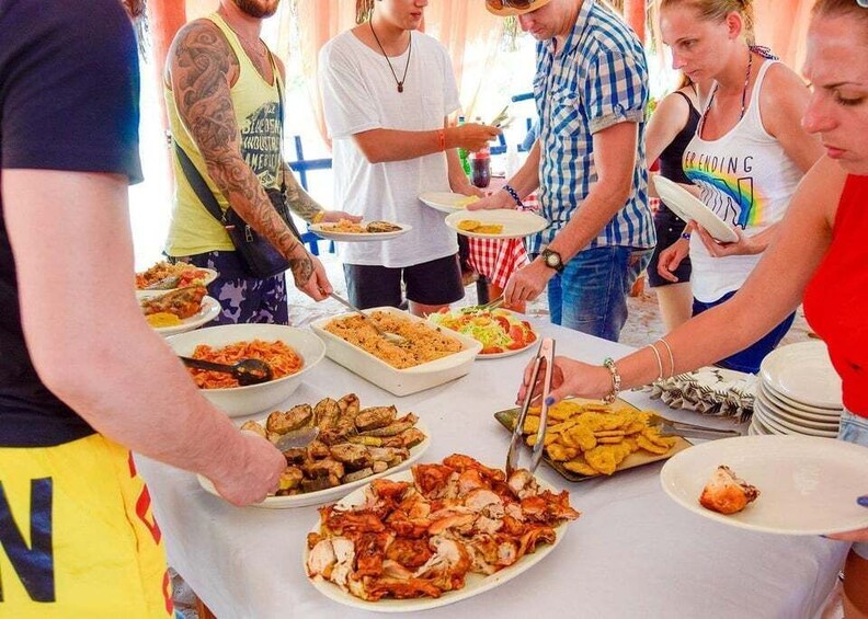 A group of people at a buffet with various dishes. 5