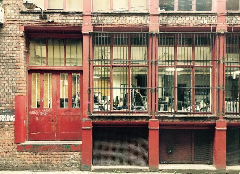 A red brick building with barred windows and a metal gate. 2