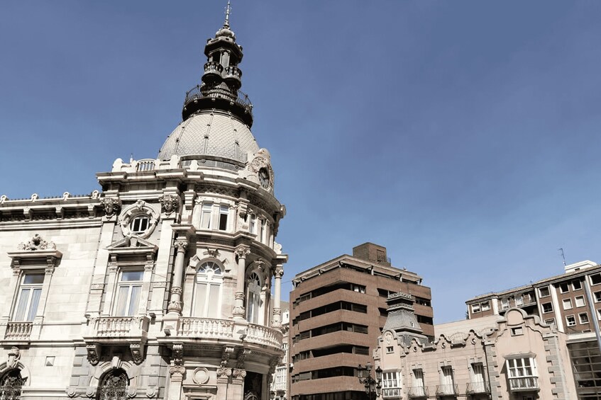 A historic building with ornate architecture, including a prominent dome and detailed facade. 4