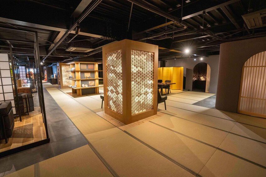 A traditional Japanese interior with tatami flooring, wooden partitions, and a modern lighting setup. 2