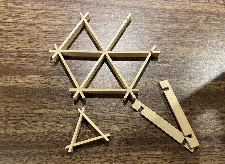 A wooden geometric structure on a wooden surface. 4
