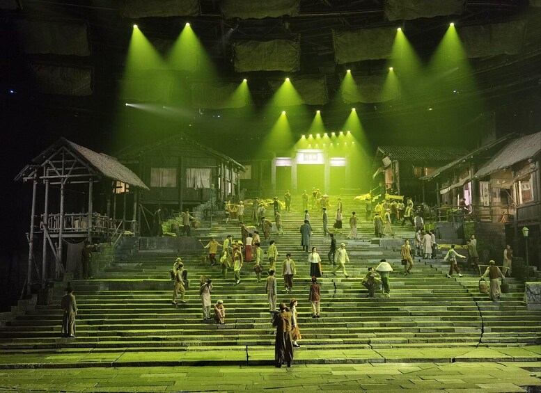 A historical theater with a stage, audience, and traditional architecture. 1