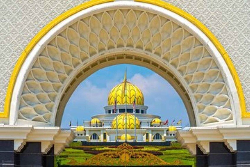 A building with a large golden dome, an arched entrance, and a flag. 4