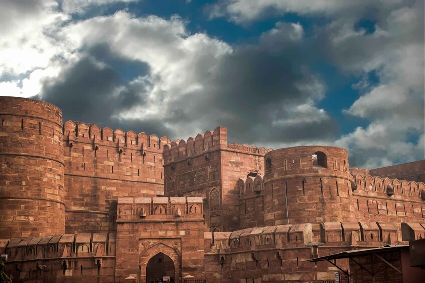 A historic fort with red brick walls and multiple towers. 4