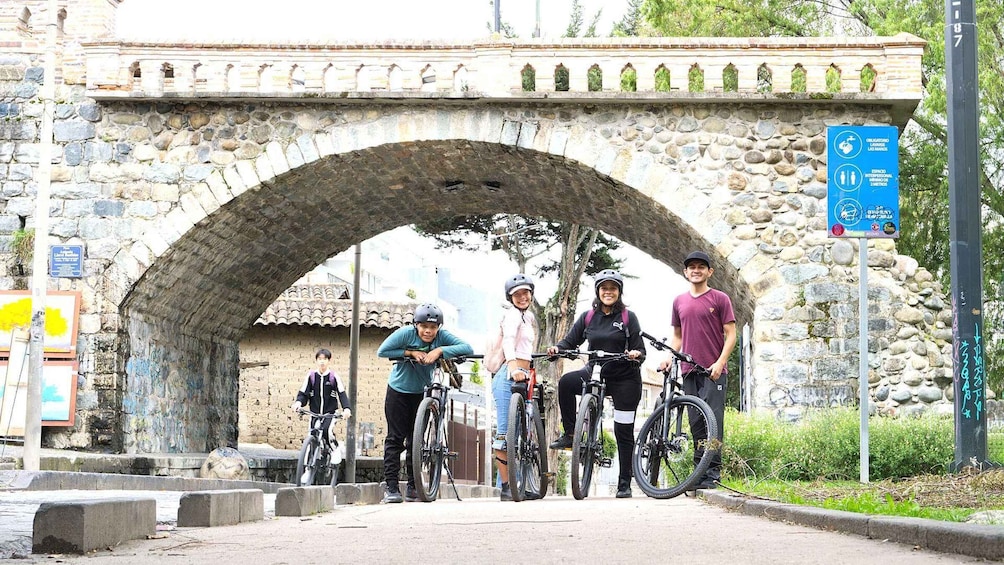 A stone bridge with cyclists underneath. 5