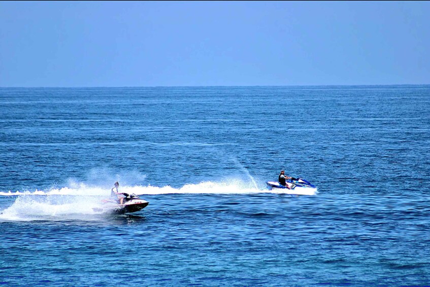 Two jet skis on a calm sea under a clear sky. 4