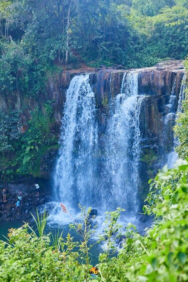 A multi-tiered waterfall surrounded by lush greenery. 2