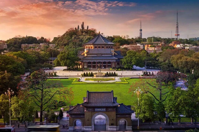 A traditional Korean gate with a symmetrical garden and a pagoda in the background. 1