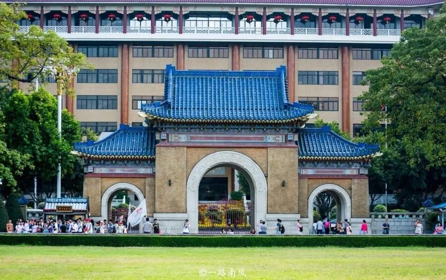 A traditional Chinese building with blue tiled roofs and a large archway. 2