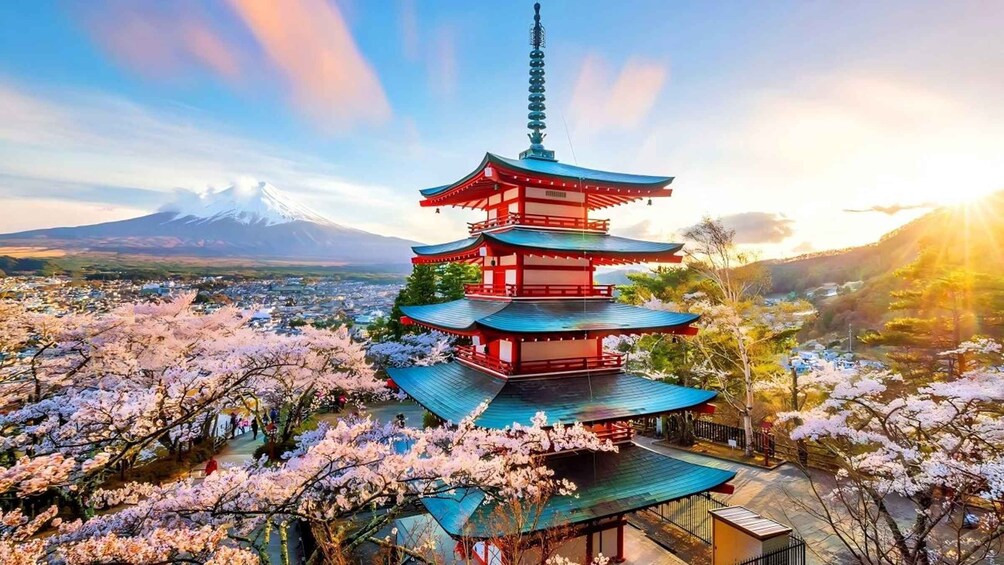 A traditional Japanese pagoda with cherry blossoms in bloom, set against a backdrop of Mount Fuji. 4