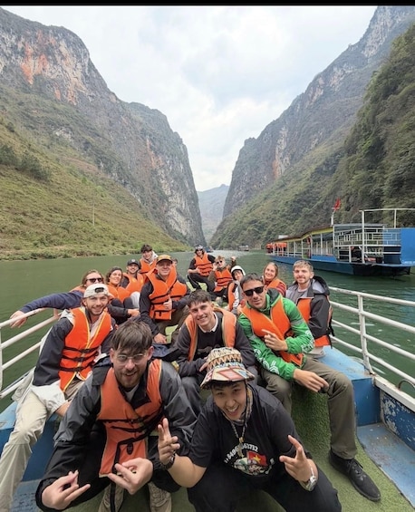A group of people on a boat in a canyon with steep cliffs. 1