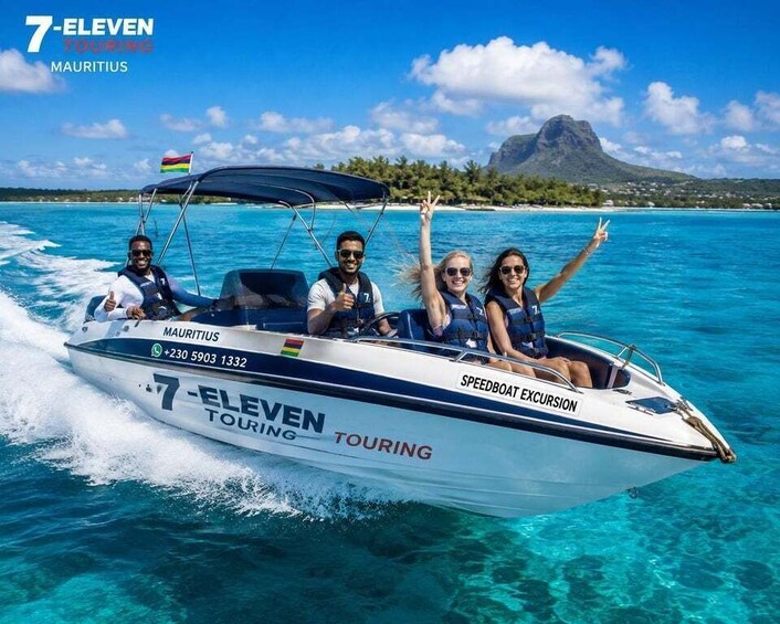 A speedboat with four passengers, a flag, and a mountainous island in the background. 2