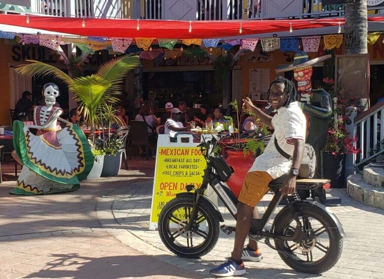 A street vendor on a bicycle, a skeleton figure, and a sign advertising Mexican food. 5