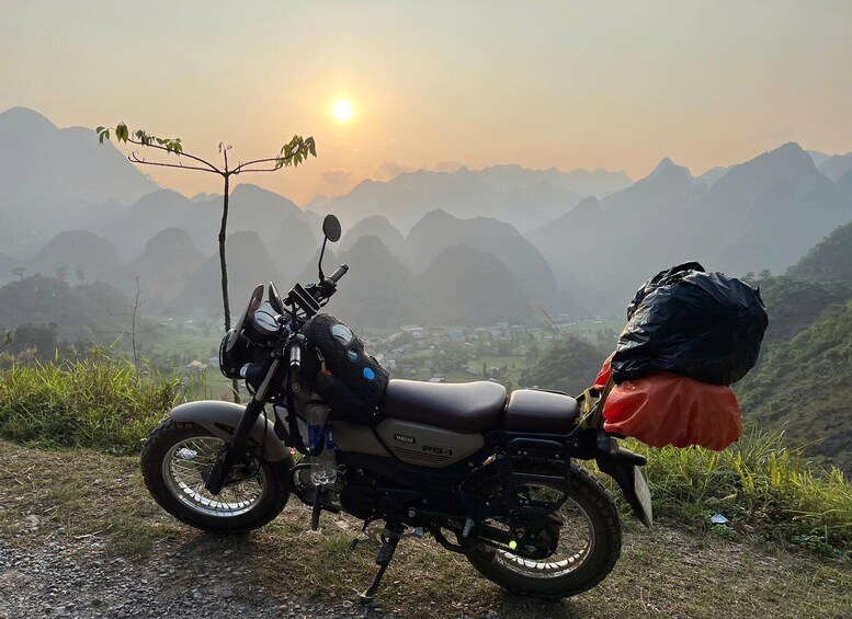 A motorcycle parked on a roadside with a mountainous landscape in the background. 3