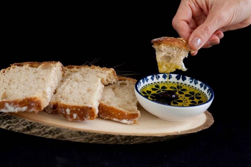 Slices of bread on a plate with a bowl of olive oil. 4