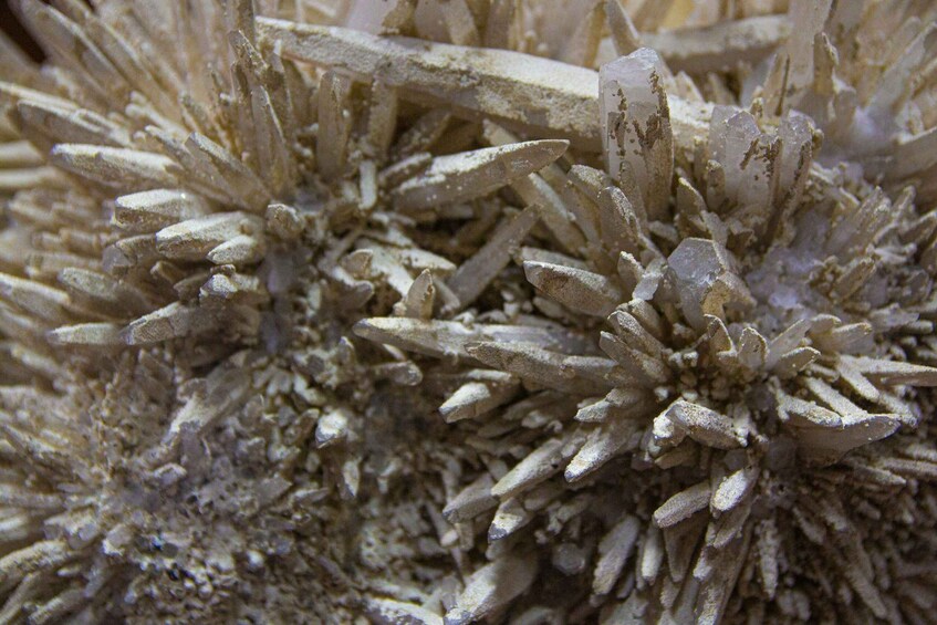 A close-up of a mineral formation with needle-like crystals. 1