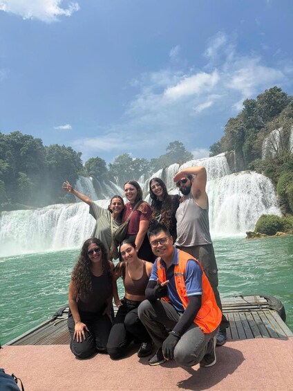 A group of people on a boat near a waterfall. 3