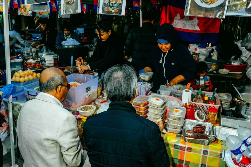 A street food stall with various food containers and a table with food items. 4