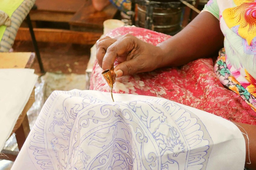 A person sewing a patterned fabric. 5