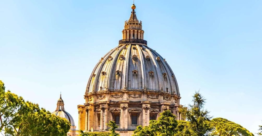 A large, domed building with classical architecture, surrounded by trees. 1