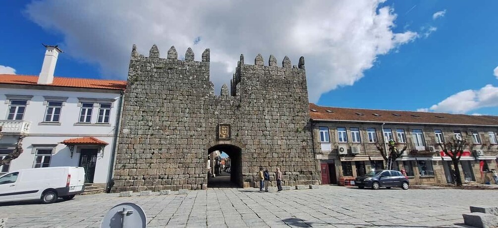 A stone castle gate with a clear sky above. 3