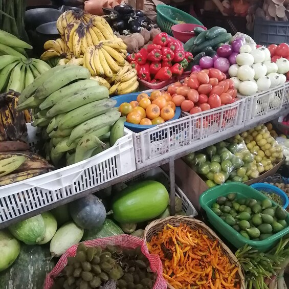 A variety of fresh produce including bananas, tomatoes, and avocados. 3