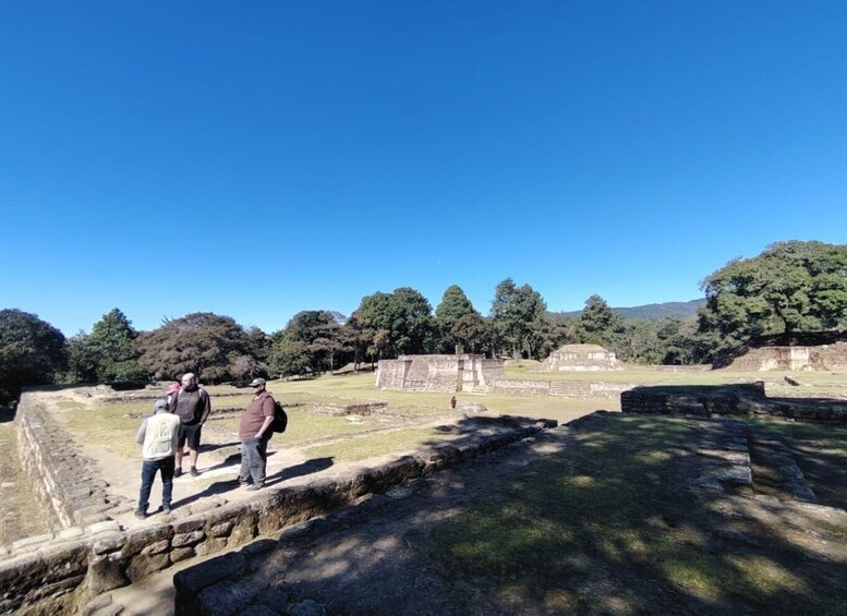 Ancient ruins with stone structures and a clear blue sky. 3