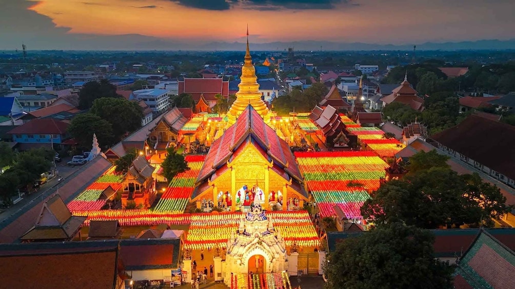A temple complex with a central stupa, surrounded by traditional buildings and colorful rooftops. 1