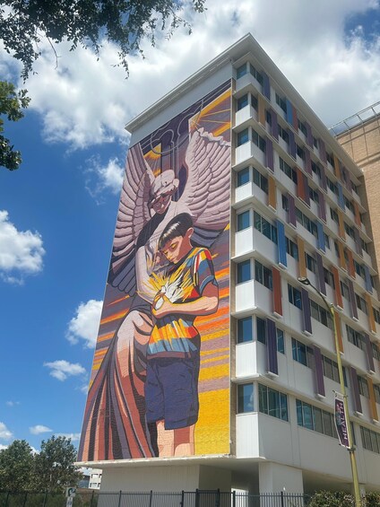 A building with a large mural of an angel and a child. 5