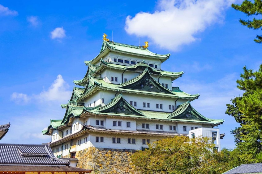 A traditional Japanese castle with multiple tiers and green roofs. 5