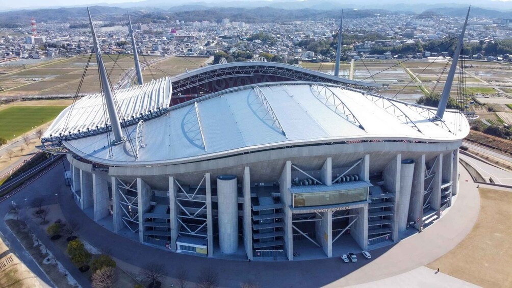 A stadium with a distinctive roof and multiple support columns. 2