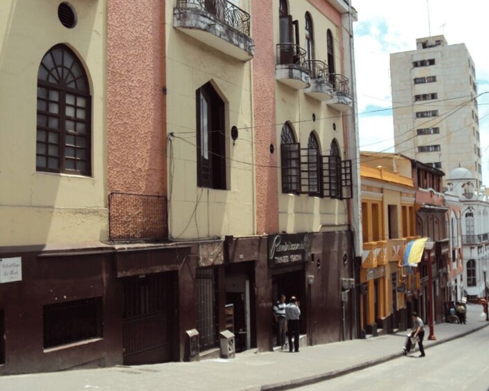 A street with buildings, including a restaurant and a bank. 4