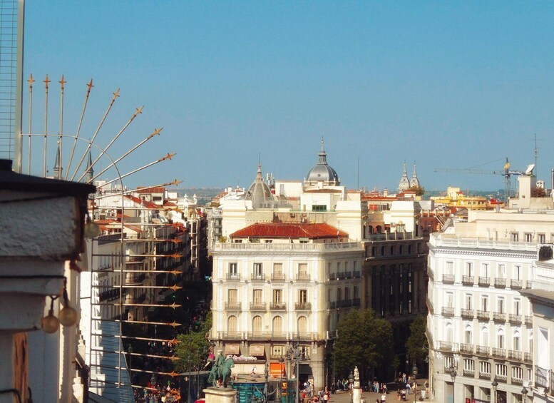 A cityscape with historic buildings, a prominent dome structure, and a Ferris wheel in the background. 3
