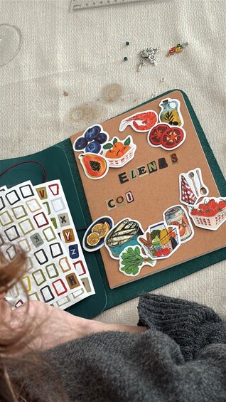 A notebook with food-themed stickers and a keyboard. 5