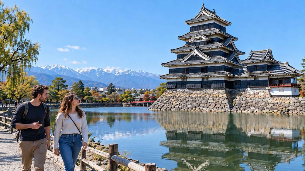 A traditional Japanese castle by a calm lake with mountains in the background. 1