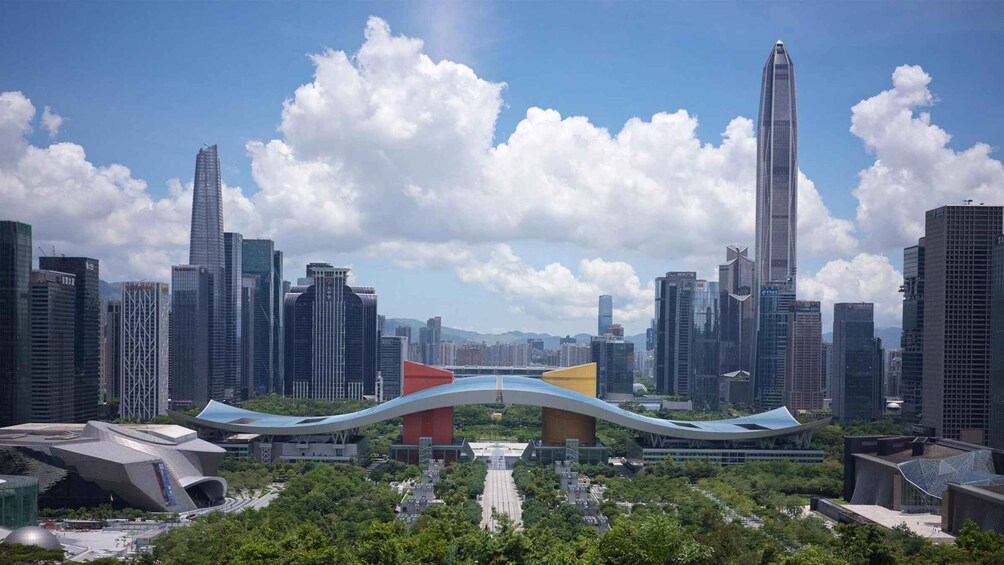 A cityscape with modern skyscrapers, a distinctive bridge, and lush greenery. 1