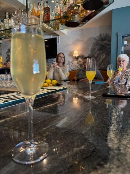 A bar with glasses of white wine and a bottle of whiskey. 5