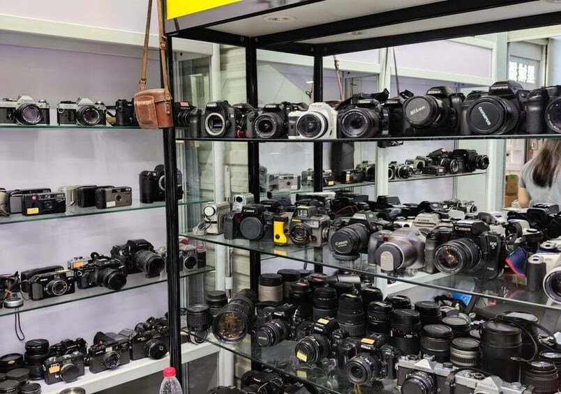 A camera store with various models displayed on shelves. 5