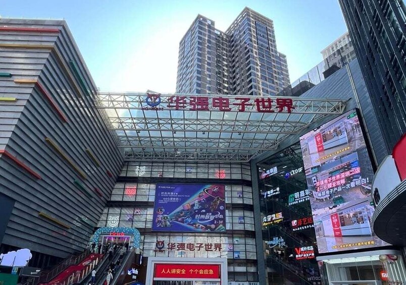 A modern building with a glass facade and a prominent red sign. 4