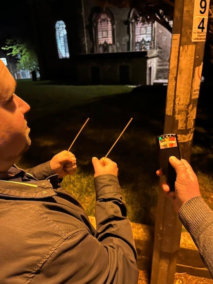 A person holding two sticks, looking at a sign with the numbers 94 and 9. 3