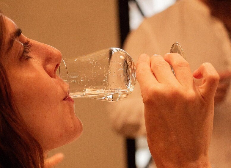 A person holding a clear glass. 5