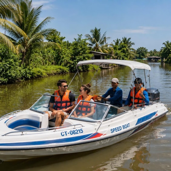 A speed boat with four people wearing life jackets on a calm river surrounded by lush greenery. 1