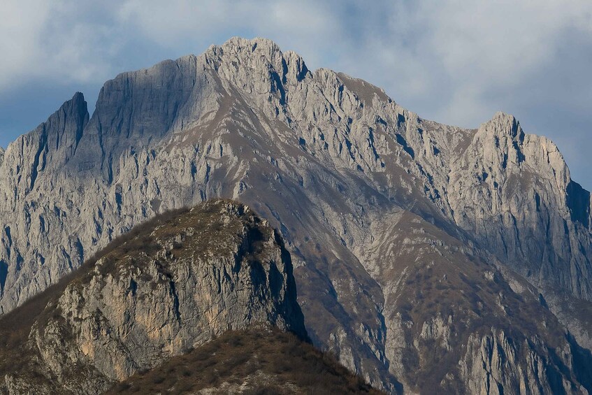 A rugged mountain range with steep, rocky slopes and a prominent peak. 3