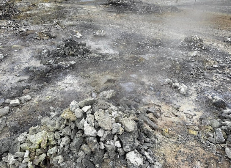 A rocky terrain with scattered boulders and a dry, uneven surface. 5